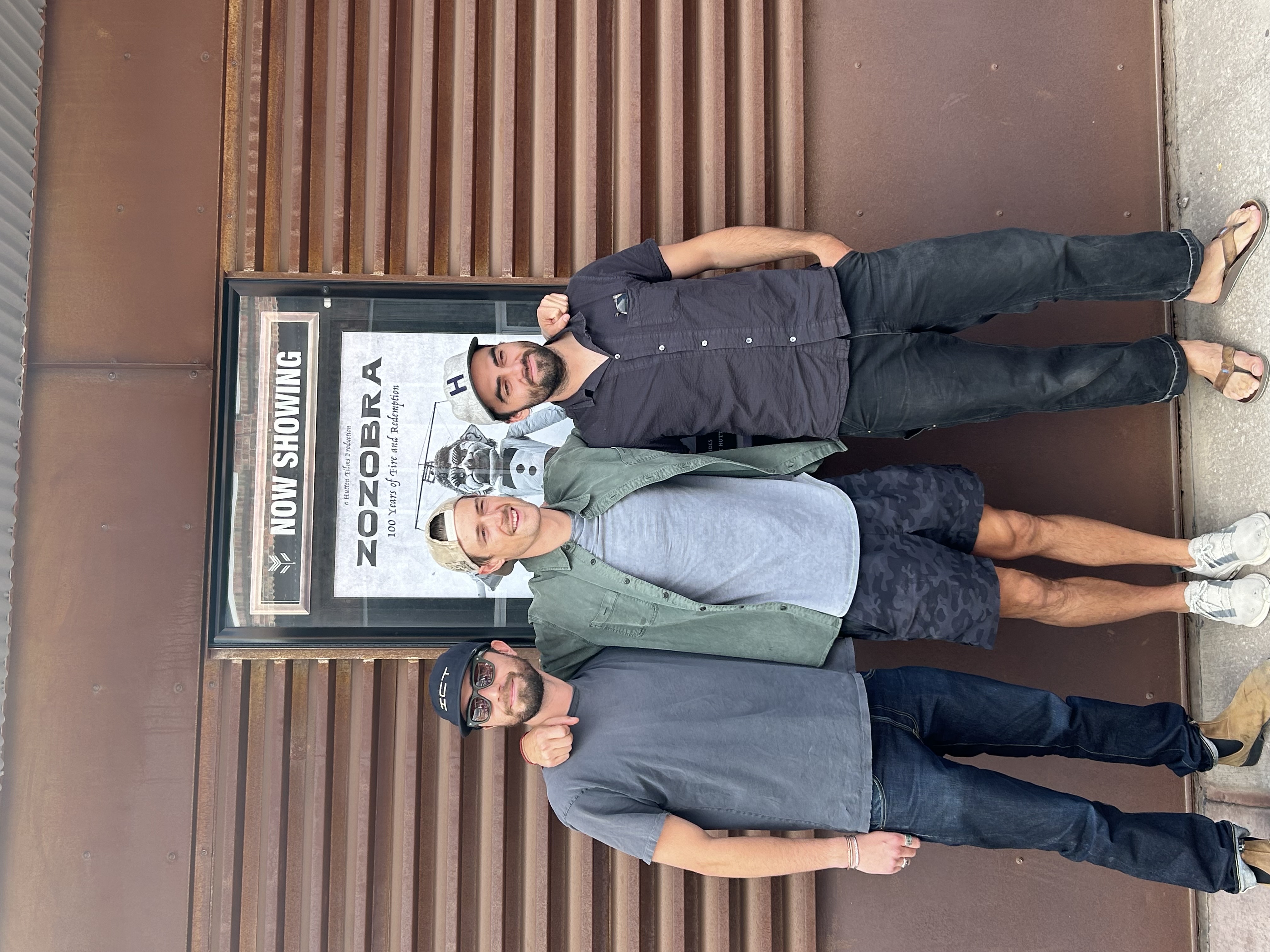 Premiere at Violet Crown Cinema — team in front of Now Showing marquee